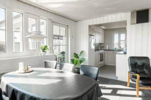 a kitchen and dining room with a table and chairs at G143-Lemvig-Syrenvej-43 in Lemvig +25 photos