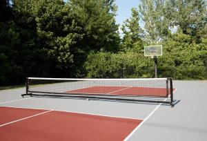 a tennis court with a net and a basketball hoop at Wlk 2 MSU Fire Pit Pickleball Sleeps 8 in Starkville