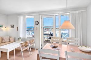 a living room with a table and a dining room at 4170-Borre-Klintholm-Havneby-70 in Borre +20 photos