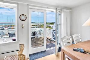 a kitchen with a table and chairs and a balcony at 4170-Borre-Klintholm-Havneby-70 in Borre