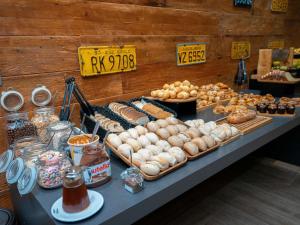 a buffet of pastries and other foods on a table at Mercure Sao Bernardo Do Campo in São Bernardo do Campo
