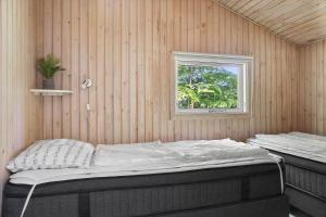 a bedroom with two beds in a wooden wall at 0651-Toftlund-Skikkild-bjerge-20 in Toftlund +43 photos