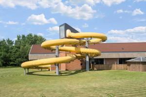 a set of yellow inflatable slides in front of a building at 0651-Toftlund-Skikkild-bjerge-20 in Toftlund