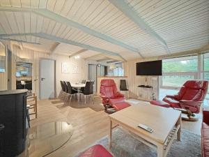 a living room with red chairs and a table at 0048-Romo-Trinnesvej-12 in Høm