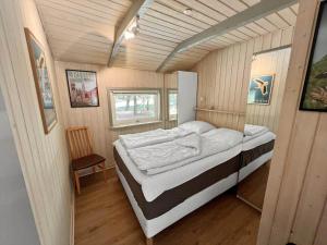 a bedroom with a bed in a tiny house at 0048-Romo-Trinnesvej-12 in Høm