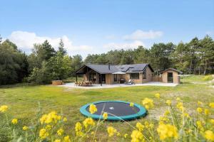 a house in the middle of a field with a trampoline at 0333-Romo-Lyngvejen-12 in Høm