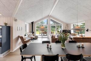 a large living room with a table and chairs at 0333-Romo-Lyngvejen-12 in Høm