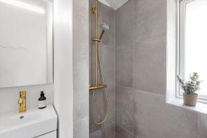 a shower with a shower head in a bathroom at 0333-Romo-Lyngvejen-12 in Høm +46 photos