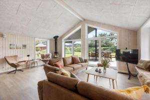 a living room with a couch and a tv at 0333-Romo-Lyngvejen-12 in Høm