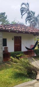 a house with a hammock in front of it at Hotel Playa Santa Martha in Rivas