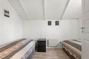 two beds in a room with white walls at 0294-Romo-Vestergade-3-Ap-57 in Høm