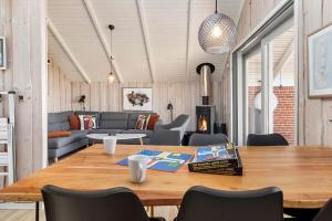 a dining room with a table and a couch at 0294-Romo-Vestergade-3-Ap-57 in Høm