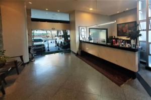 a lobby of a salon with a reception desk and a waiting room at Via Contorno Hotel in Belo Horizonte