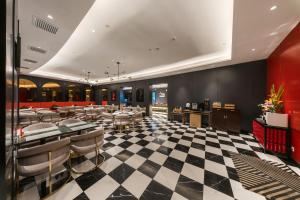 a restaurant with a black and white checkered floor at Radisson RED Shanghai Wujiaochang Hotel in Shanghai