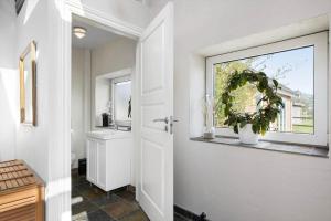 a bathroom with a white door and a window at 0057-Romo-Juvrevej-49 in Høm +37 photos
