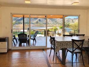 a dining room with a table and chairs and a balcony at Mirabela Casa con vista panorámica a las sierras en Bialet Massé- Hasta 4 personas in Bialet Massé