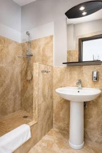 a bathroom with a sink and a shower at Апартаменти Мост Сіті in Dnipro