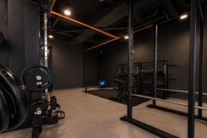 a gym with a weight room with two racks of equipment at Metropolitan Living by HOUSY in Medellín