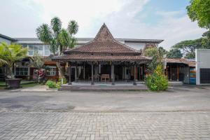a building with a tile roof on a street at The Lavana Astungkara in Beran-kidul