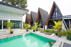 a house with a swimming pool in front of it at The Lavana Astungkara in Beran-kidul