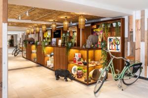 a shop with a cat and a bike in a room at INNSiDE by Meliá Alcudia in Port d'Alcudia