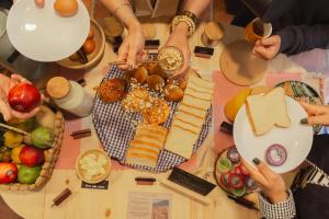a group of people sitting around a table with food at Casa Aura Hotel in Bogotá