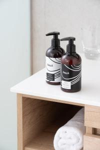 two bottles of soap sitting on a shelf at INNSiDE by Meliá Wave Calviá in Magaluf