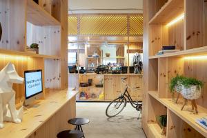 a room with wooden walls and a desk with a bike at INNSiDE by Meliá Calviá Beach in Magaluf