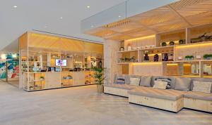 a store with couches and shelves in a room at INNSiDE by Meliá Calviá Beach in Magaluf