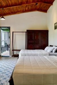 a bedroom with a large bed with a wooden headboard at Laman Riverside in Nguyên Ngoại