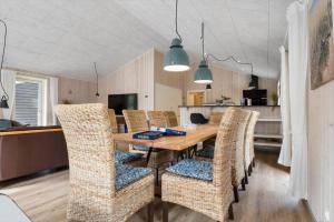 a dining room with a wooden table and chairs at 2807-Romo-A-Hveyselsvej-28 in Høm