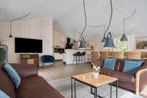 a living room with two brown couches and a table at 2807-Romo-A-Hveyselsvej-28 in Høm