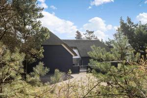 a house with a garage and some trees at 2807-Romo-A-Hveyselsvej-28 in Høm