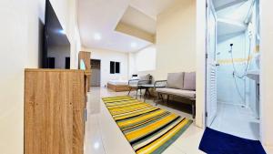 a living room with a couch and a rug at Vista Residence Patong in Patong Beach