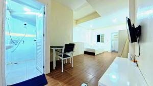 a room with a shower and a desk and a chair at Vista Residence Patong in Patong Beach +90 photos