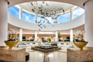 a lobby with a large ceiling with a chandelier at Gran Meliá Palacio de Isora Resort & Spa in Alcalá +173 photos