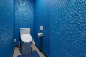 a bathroom with a blue wall with a toilet at STEP by STEP - Vacation STAY 25751v in Kanayama