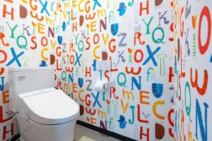 a bathroom with a toilet and a wall covered in graffiti at STEP by STEP - Vacation STAY 25756v in Kanayama