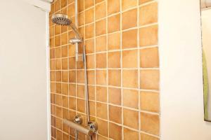 a shower in a bathroom with brown tiles at 15524-Farevejle-Lynghoj-5 in Fårevejle +16 photos