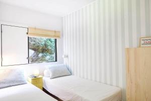 a bedroom with two beds and a window at 10000-1-Rorvig-Birkealle-2-A in Rørvig