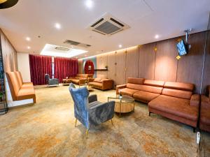 a large living room with couches and chairs at Seeds Hotel Premier Sri Petaling in Kuala Lumpur