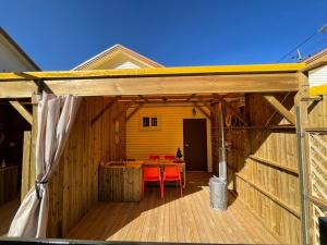 a wooden house with a table and chairs on a deck at Pocheon Yolafongta Pension in Pocheon