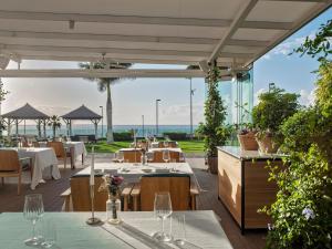 a restaurant with a view of the ocean at RedLevel at Gran Meliá Palacio de Isora - Adults Only in Alcalá