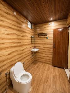 a bathroom with a toilet and a sink at VIVIPRA Habitat, Coorg in Madikeri