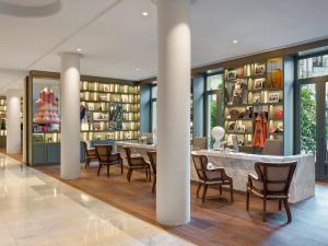 a dining room with a table and chairs in a building at Hotel Colón, a Gran Meliá Hotel - The Leading Hotels of the World in Seville +112 photos