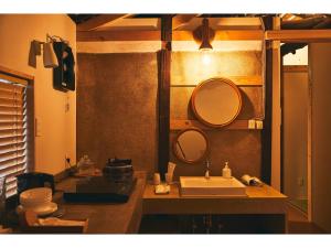 a bathroom with a sink and two mirrors on the wall at Batonship - Vacation STAY 12907 in Osaka +9 photos
