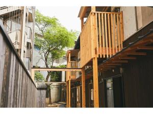 a building with wooden stairs on the side of it at Batonship - Vacation STAY 12907 in Osaka