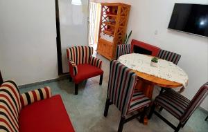 a dining room with a table and chairs and a television at Home Talampaya in Villa Unión