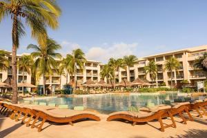 a resort swimming pool with lounge chairs and palm trees at Paradisus by Meliá La Perla - Adults Only - Riviera Maya - All Inclusive in Playa del Carmen +133 photos