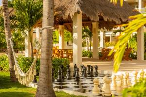 a chess board on a lawn in front of a resort at Paradisus by Meliá La Perla - Adults Only - Riviera Maya - All Inclusive in Playa del Carmen